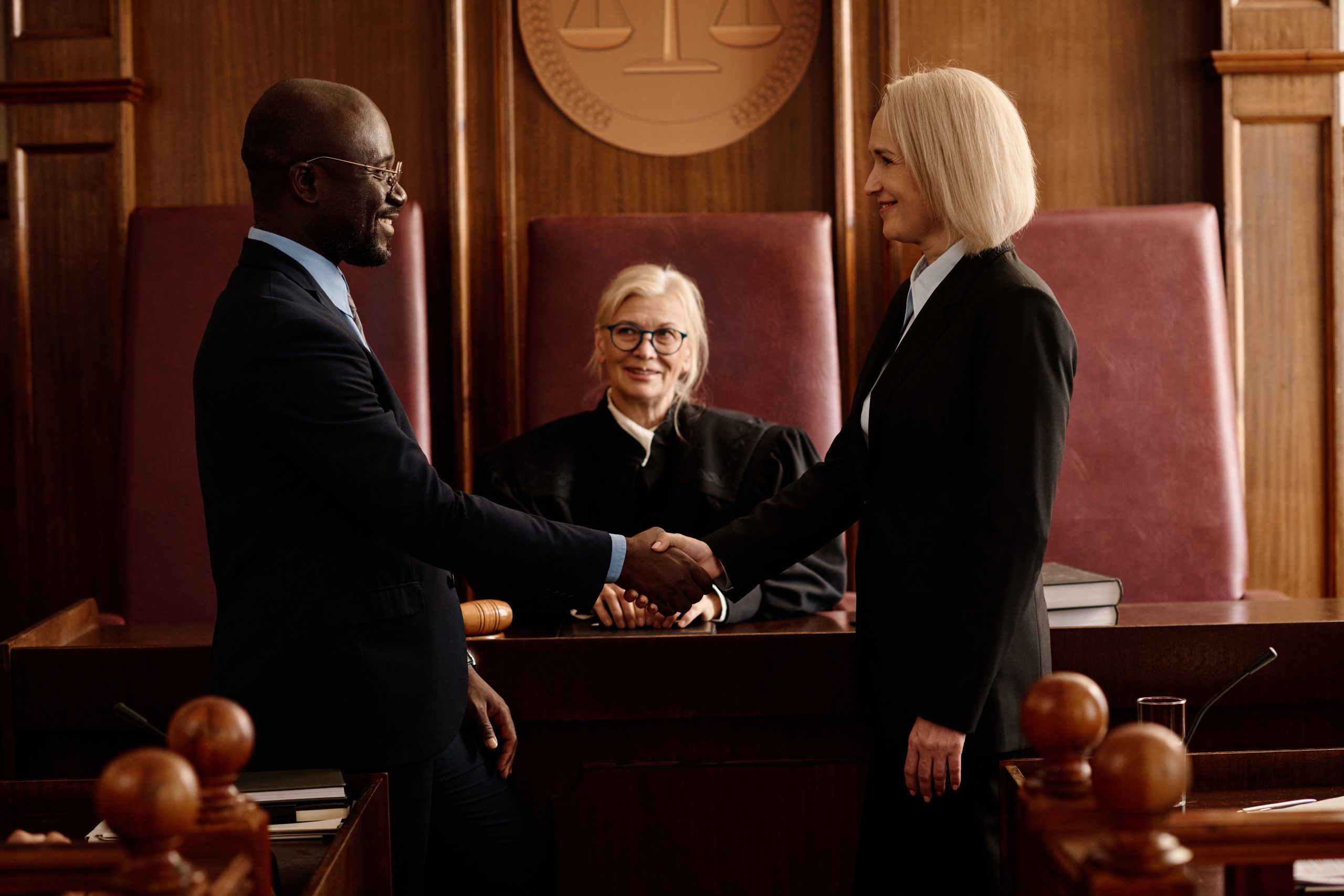 side-view-of-happy-prosecutor-and-attorney-shaking-2023-11-27-05-25-59-utc
